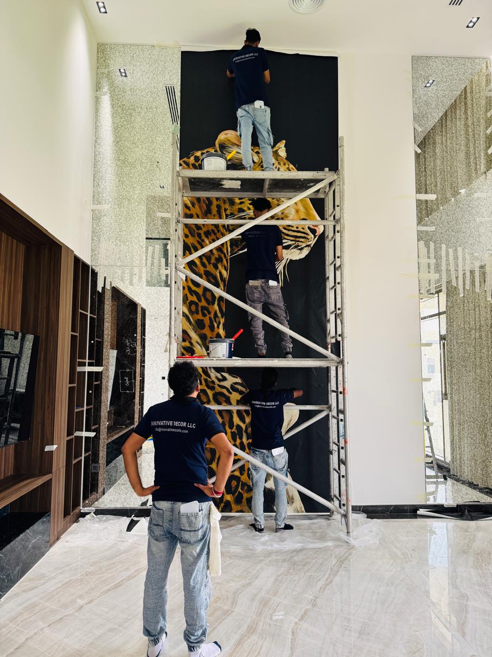 Installers fitting a large format feature wall