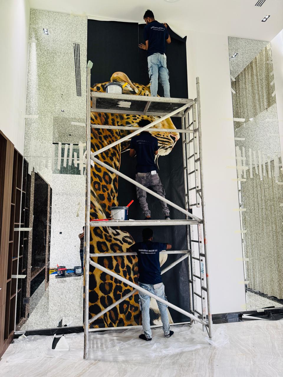 Installer aligning wallpaper on a feature wall