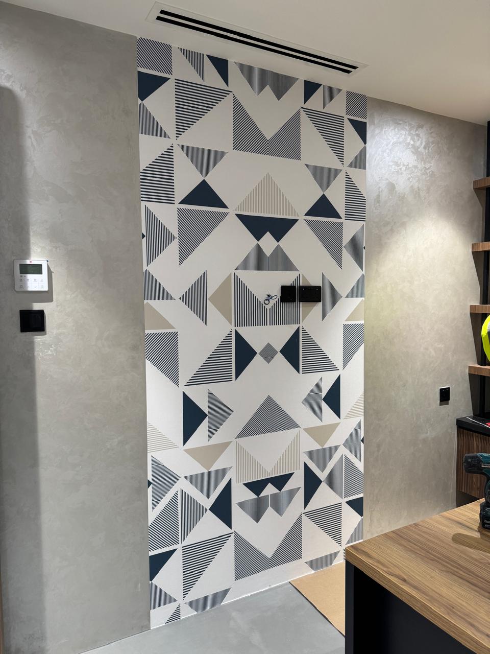 Geometric wallpaper installed on a residential feature wall