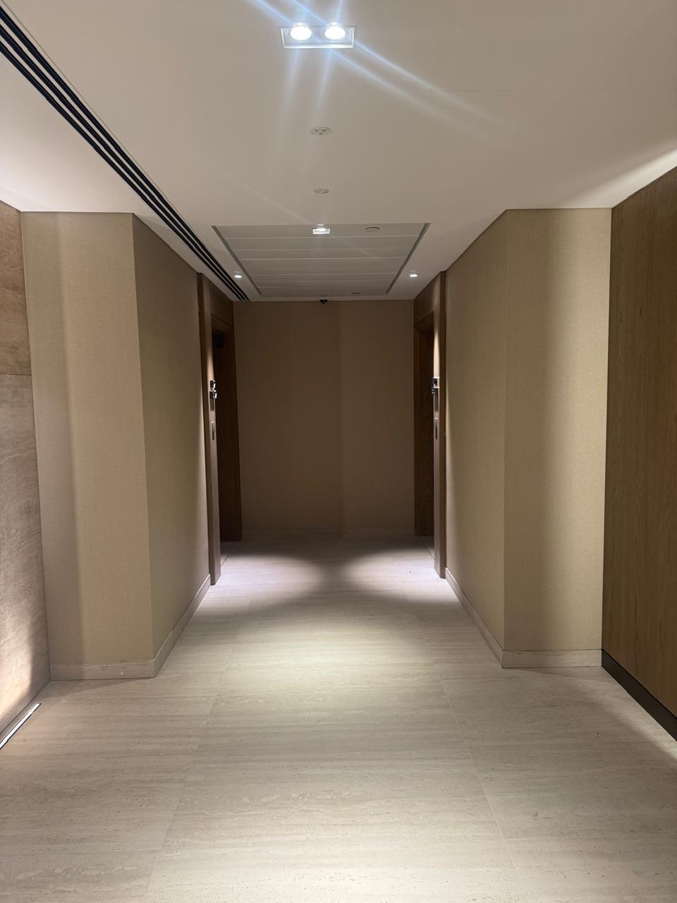 Textured wallpaper installed in a hotel lift lobby